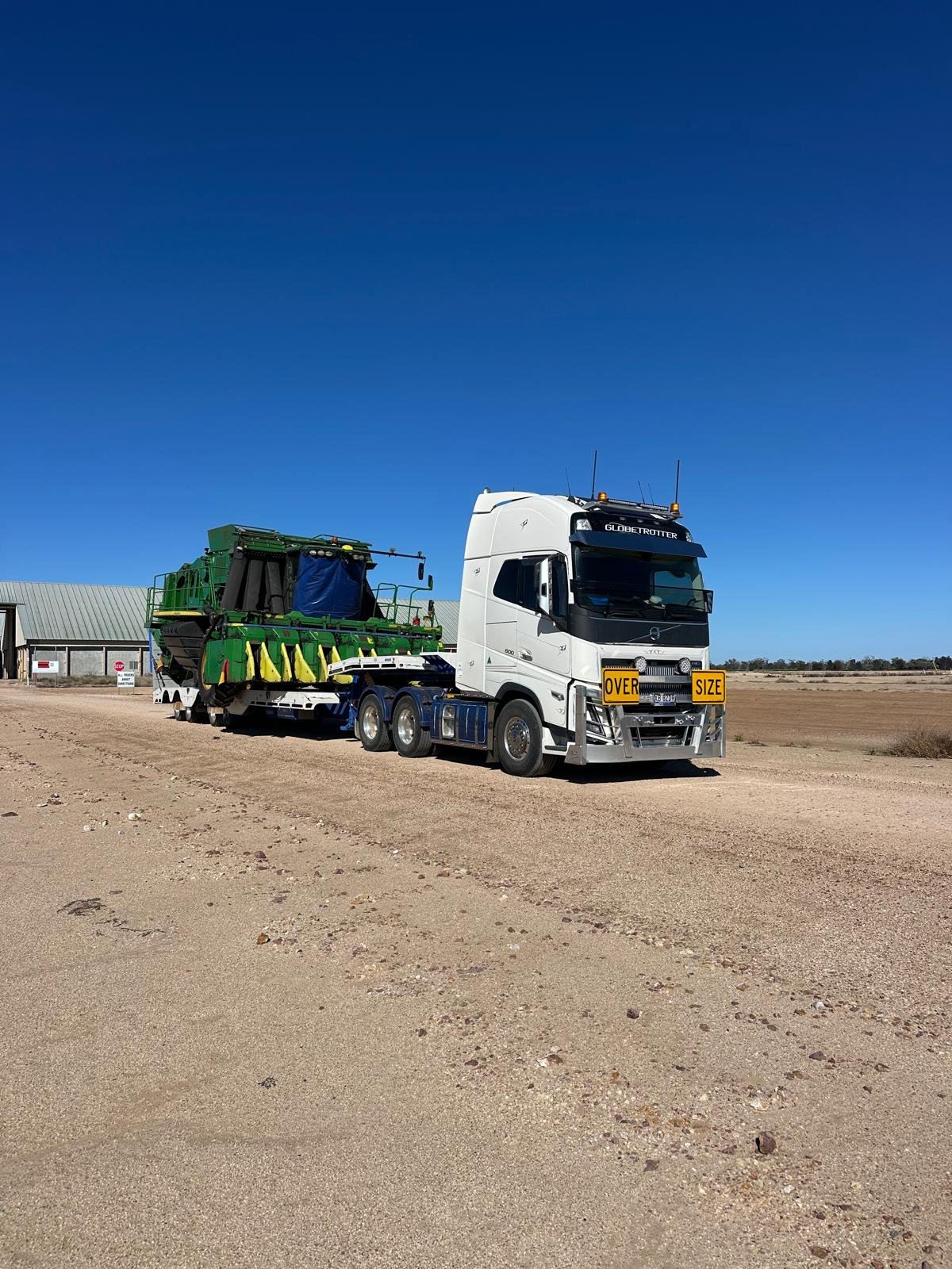 Trucks travelling down a dirt road
